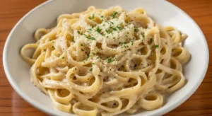 Olive Garden Fettuccine Alfredo with creamy Parmesan sauce and parsley garnish.