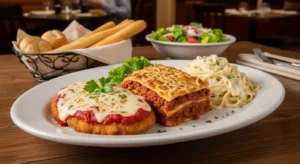 Olive Garden Tour of Italy with Chicken Parmigiana, Lasagna Classico, and Fettuccine Alfredo on a plate.
